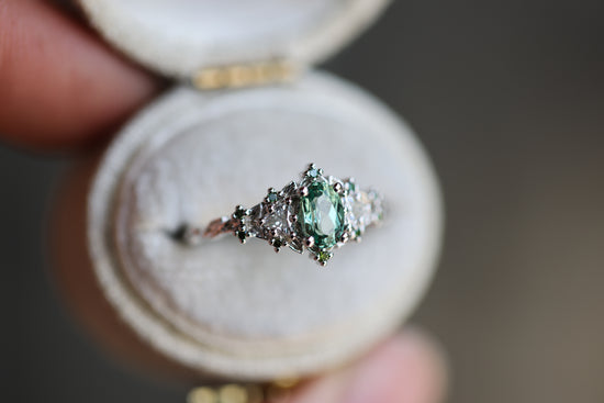 Briar rose three stone with oval lab green sapphire and green diamond accents