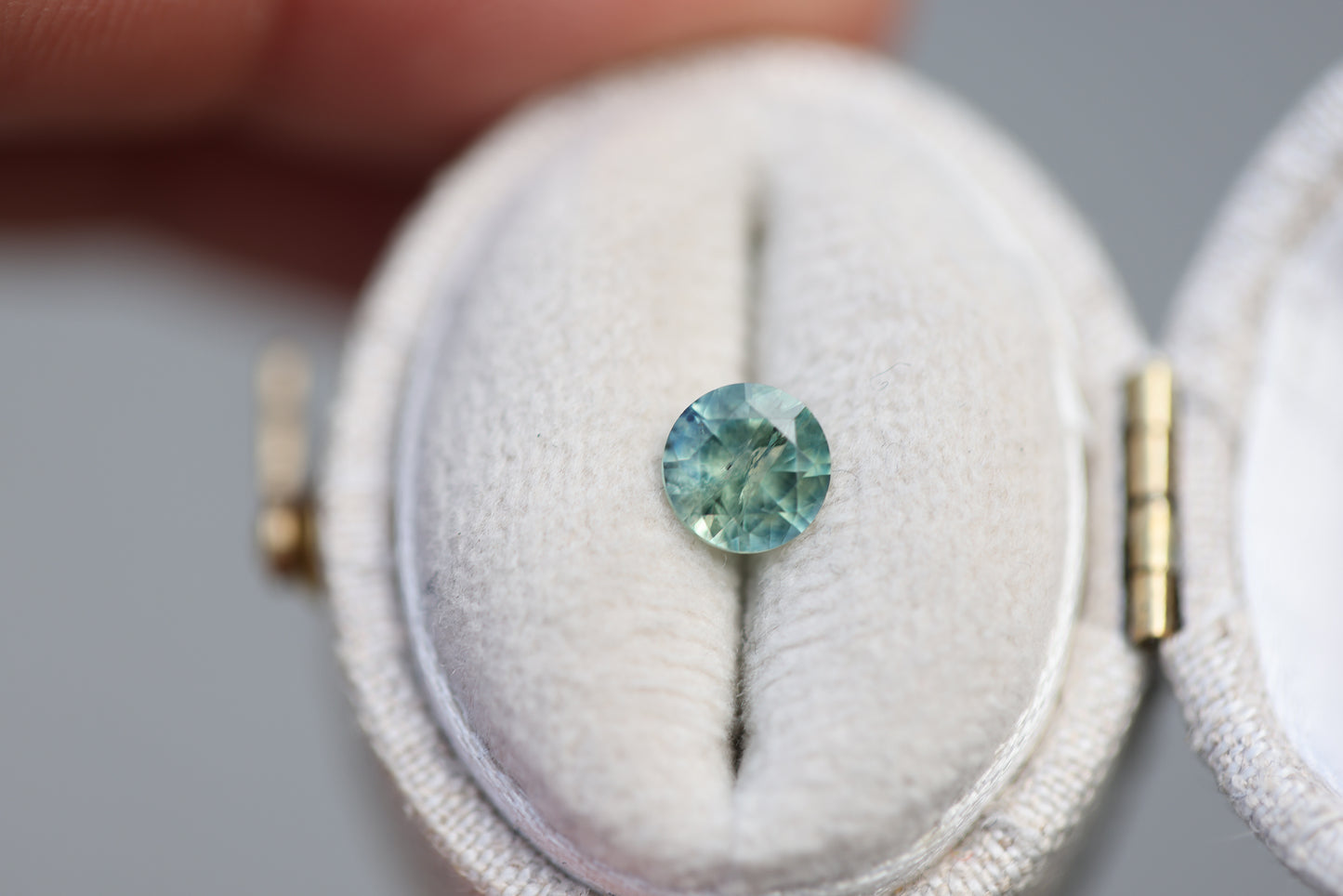 .73ct round teal green sapphire