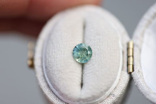 Load image into Gallery viewer, .73ct round teal green sapphire
