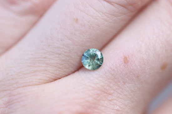 Load image into Gallery viewer, .73ct round teal green sapphire
