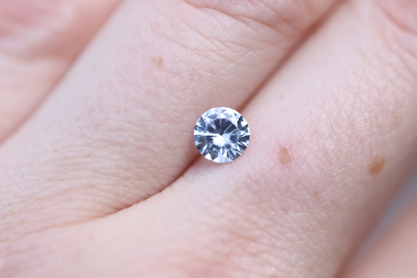 Load image into Gallery viewer, .86ct round light blue silver sapphire
