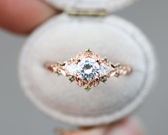 Briar rose three stone with 5.5mm round moissanite and green diamonds accents