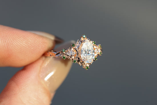 Briar moon three stone with 8x5mm pear moissanite and dark green diamonds