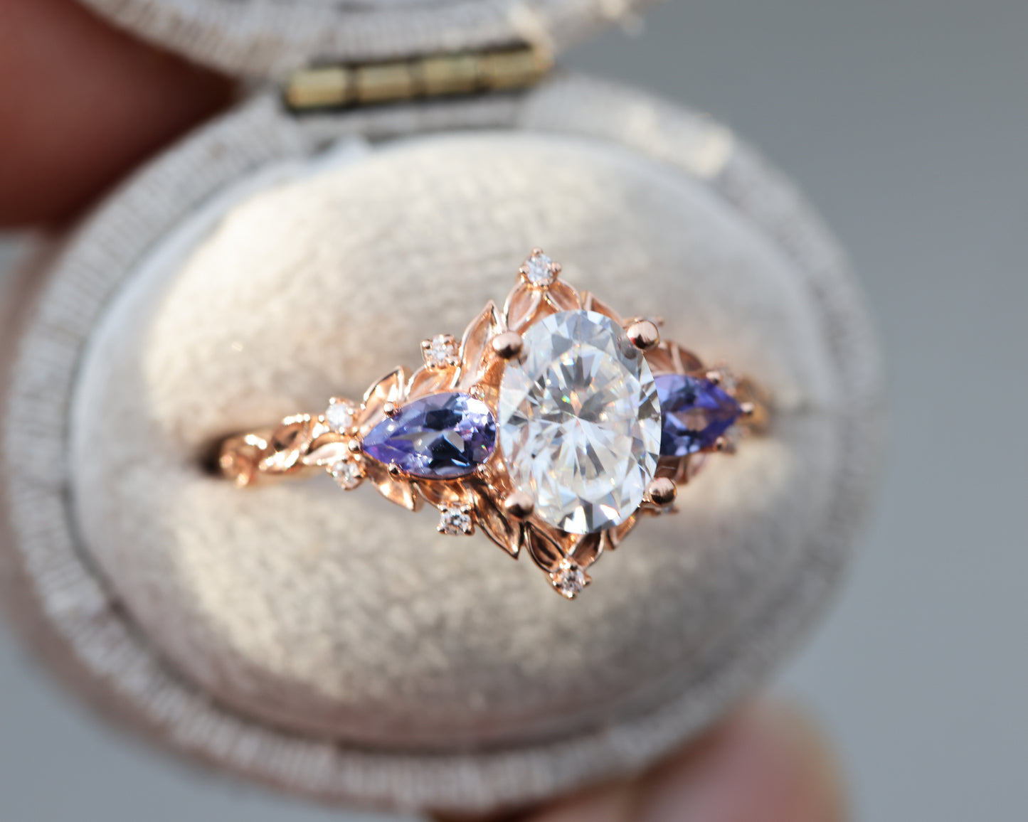 Load image into Gallery viewer, Briar rose three stone with 8x6mm oval moissanite and pear tanzanite
