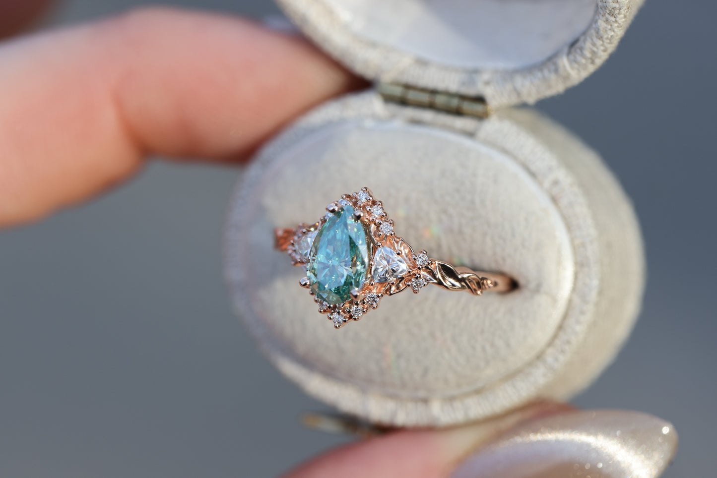 Briar half halo with 8x5mm pear teal moissanite