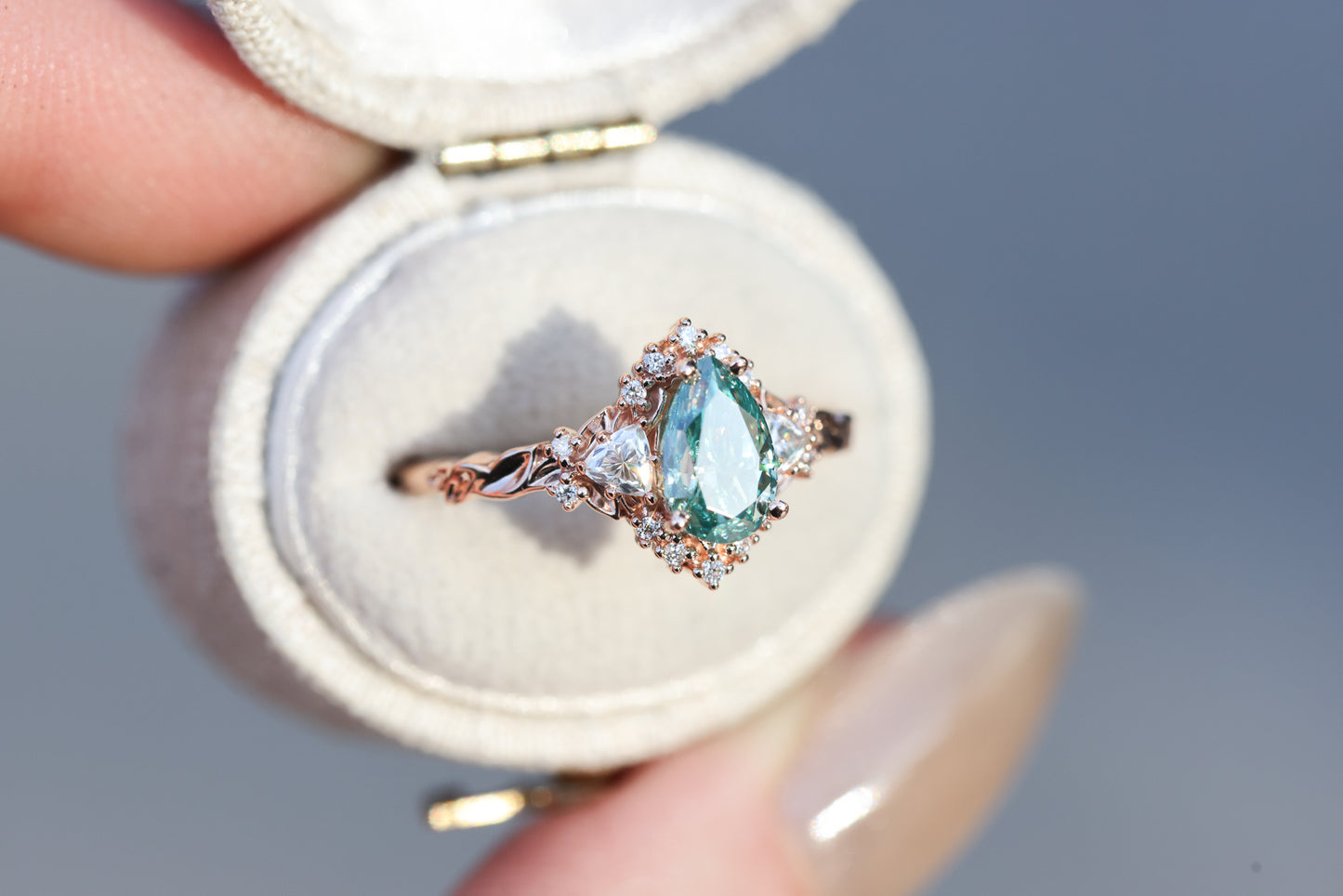 Briar half halo with 8x5mm pear teal moissanite