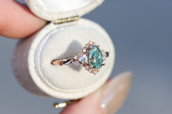 Briar half halo with 8x5mm pear teal moissanite