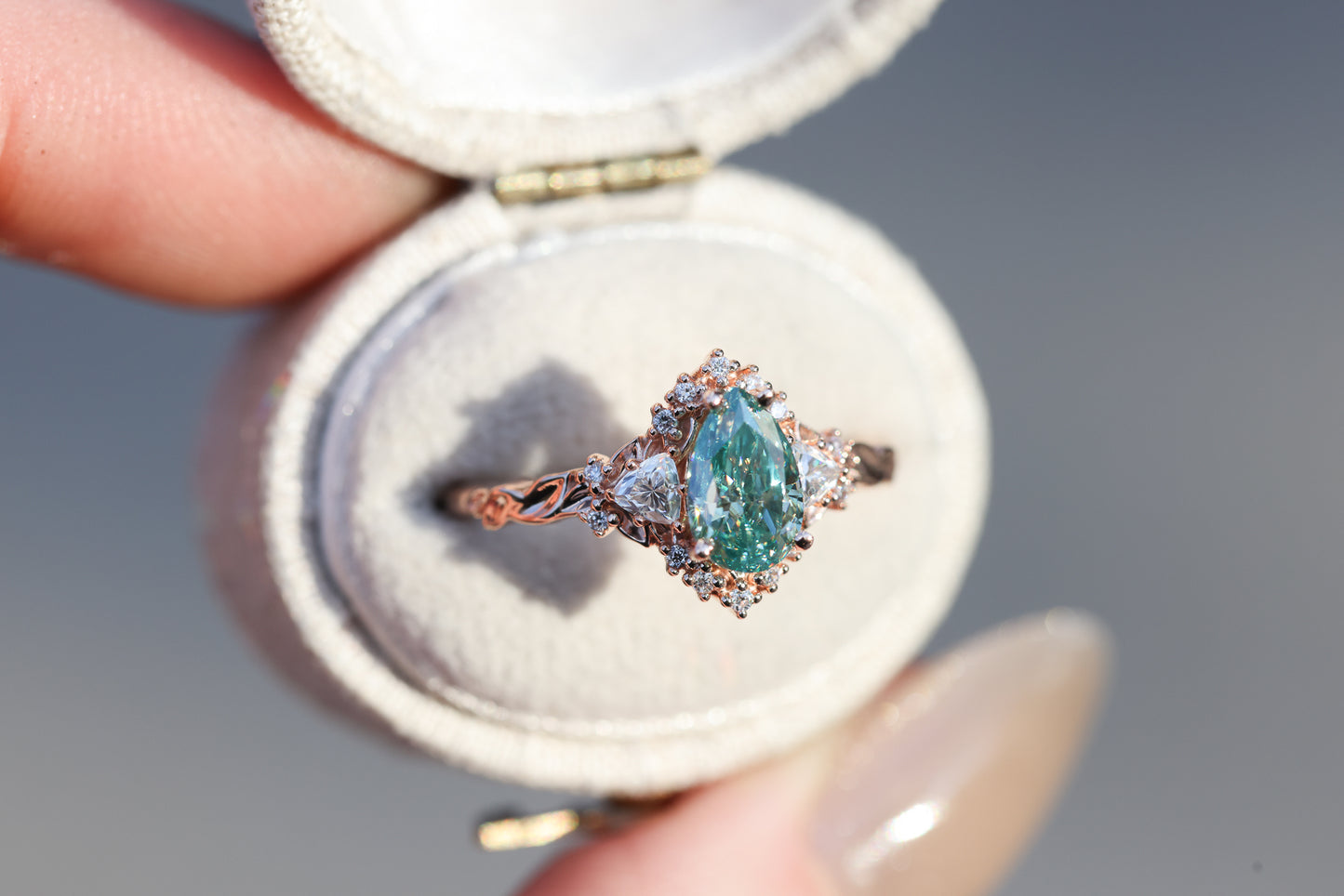 Briar half halo with 8x5mm pear teal moissanite