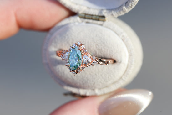 Briar half halo with 8x5mm pear teal moissanite