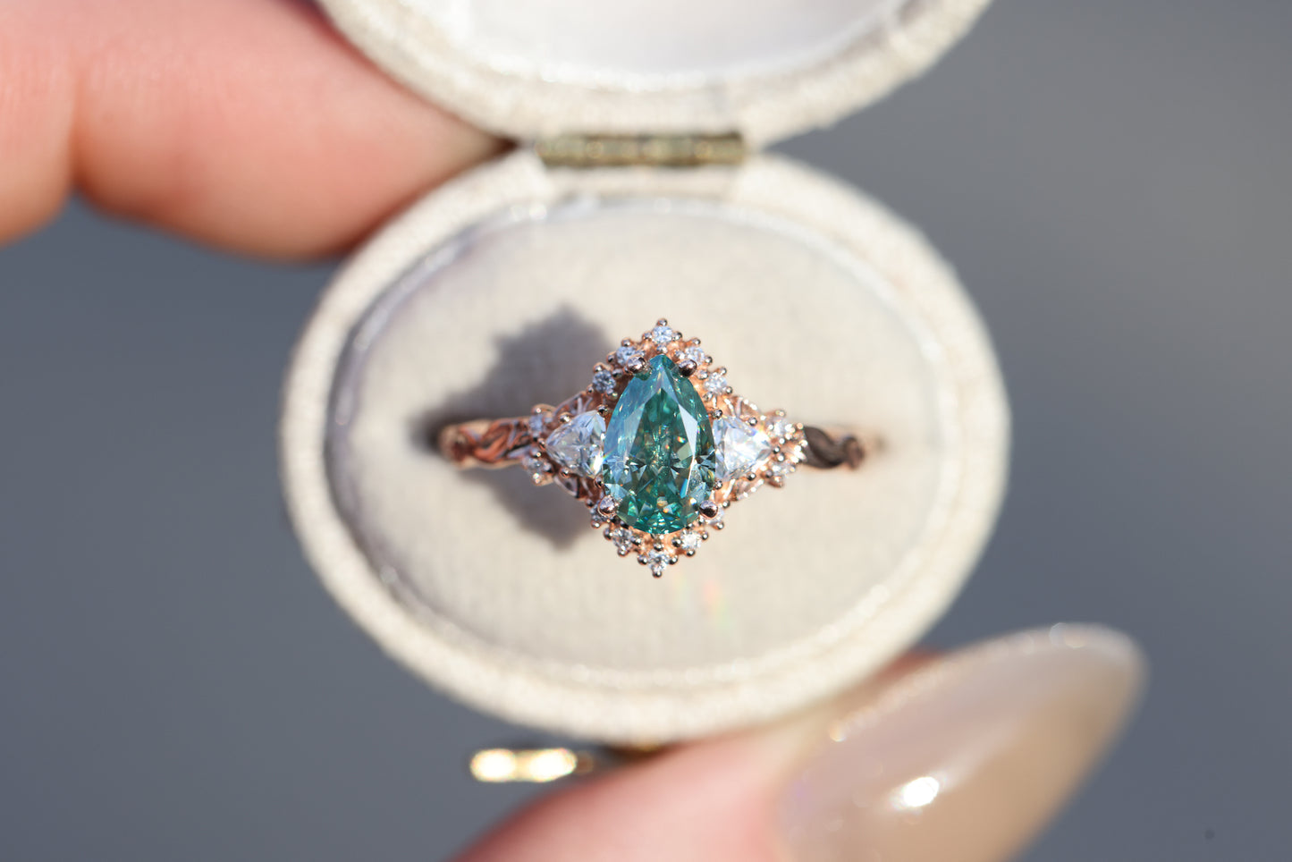 Briar half halo with 8x5mm pear teal moissanite