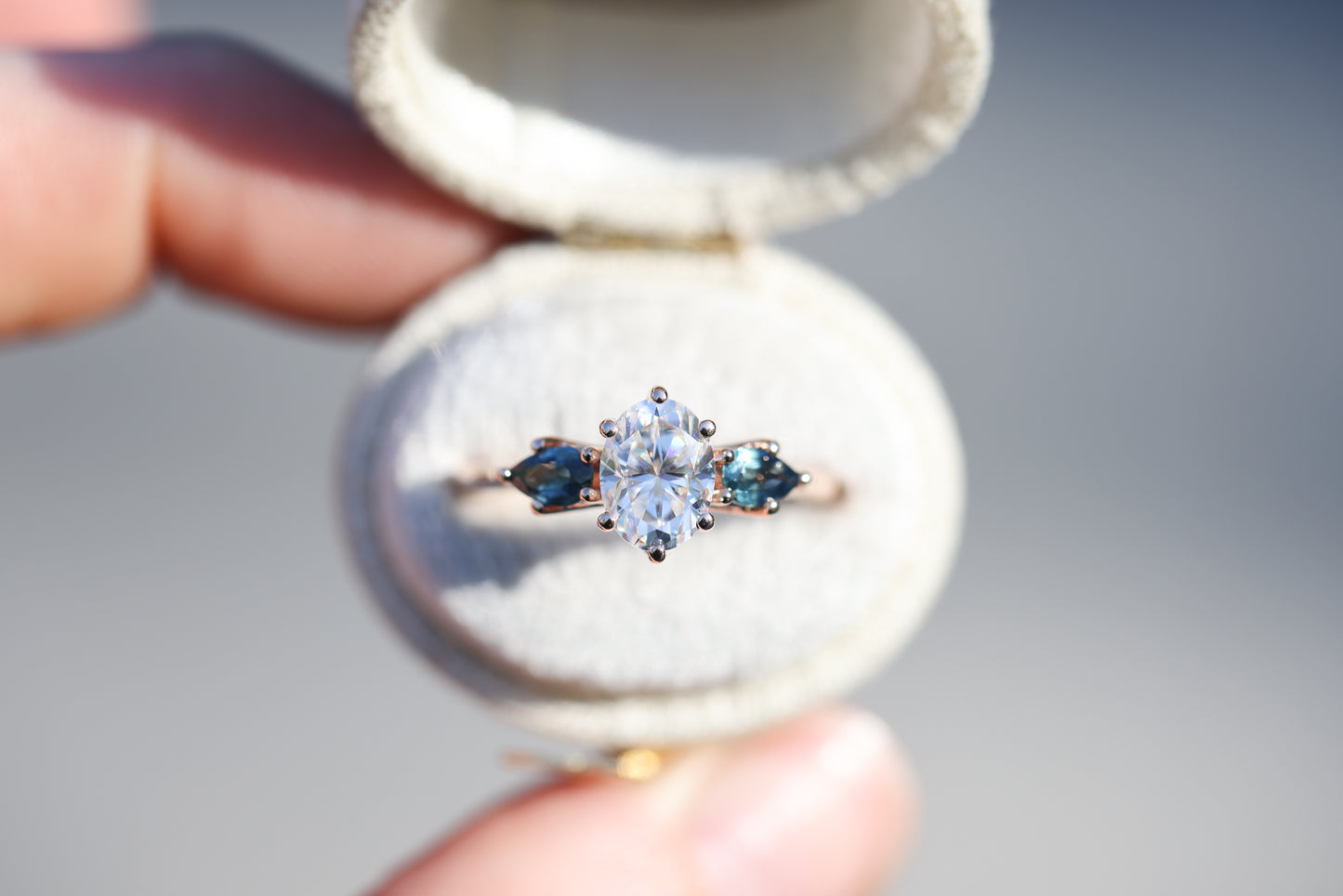 Lattice three stone setting with moissanite and blue teal sapphires