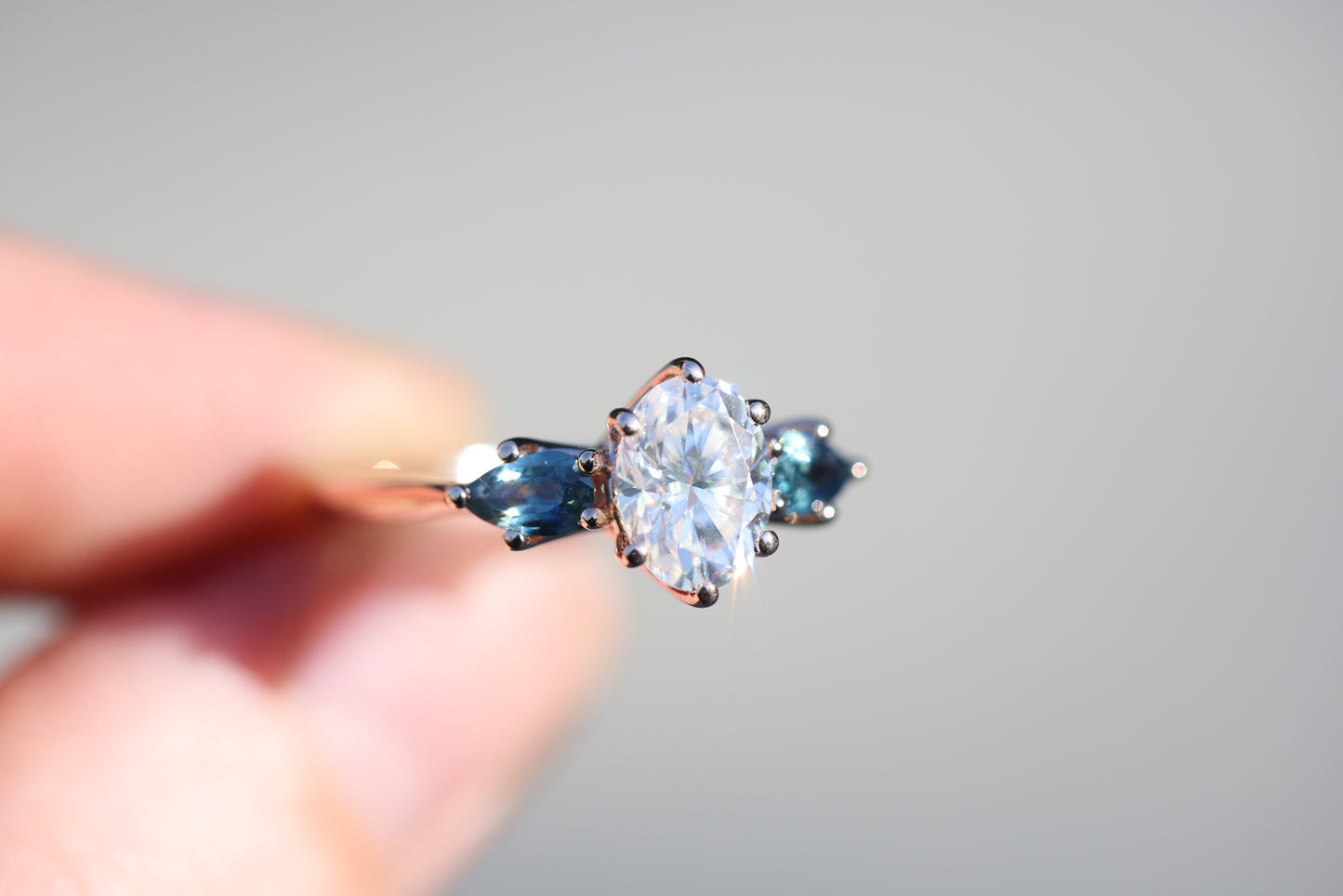 Lattice three stone setting with moissanite and blue teal sapphires
