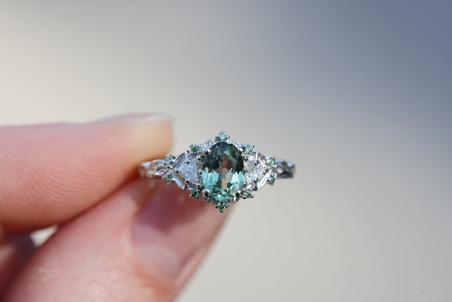 Briar Rose Three Stone with 7x5mm oval light green sapphire and mint accents