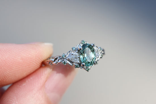 Briar Rose Three Stone with 7x5mm oval light green sapphire and mint accents