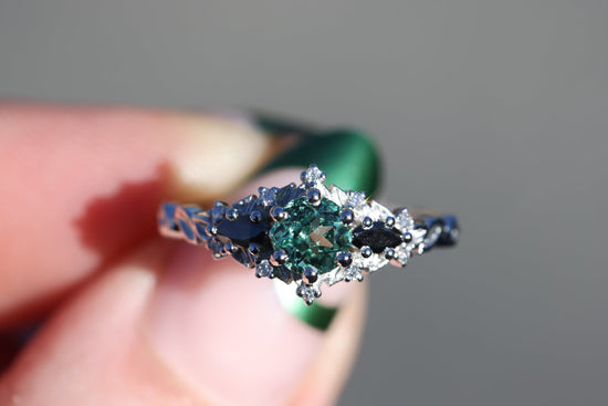 Briar rose three stone with round lab green sapphire center and black diamonds