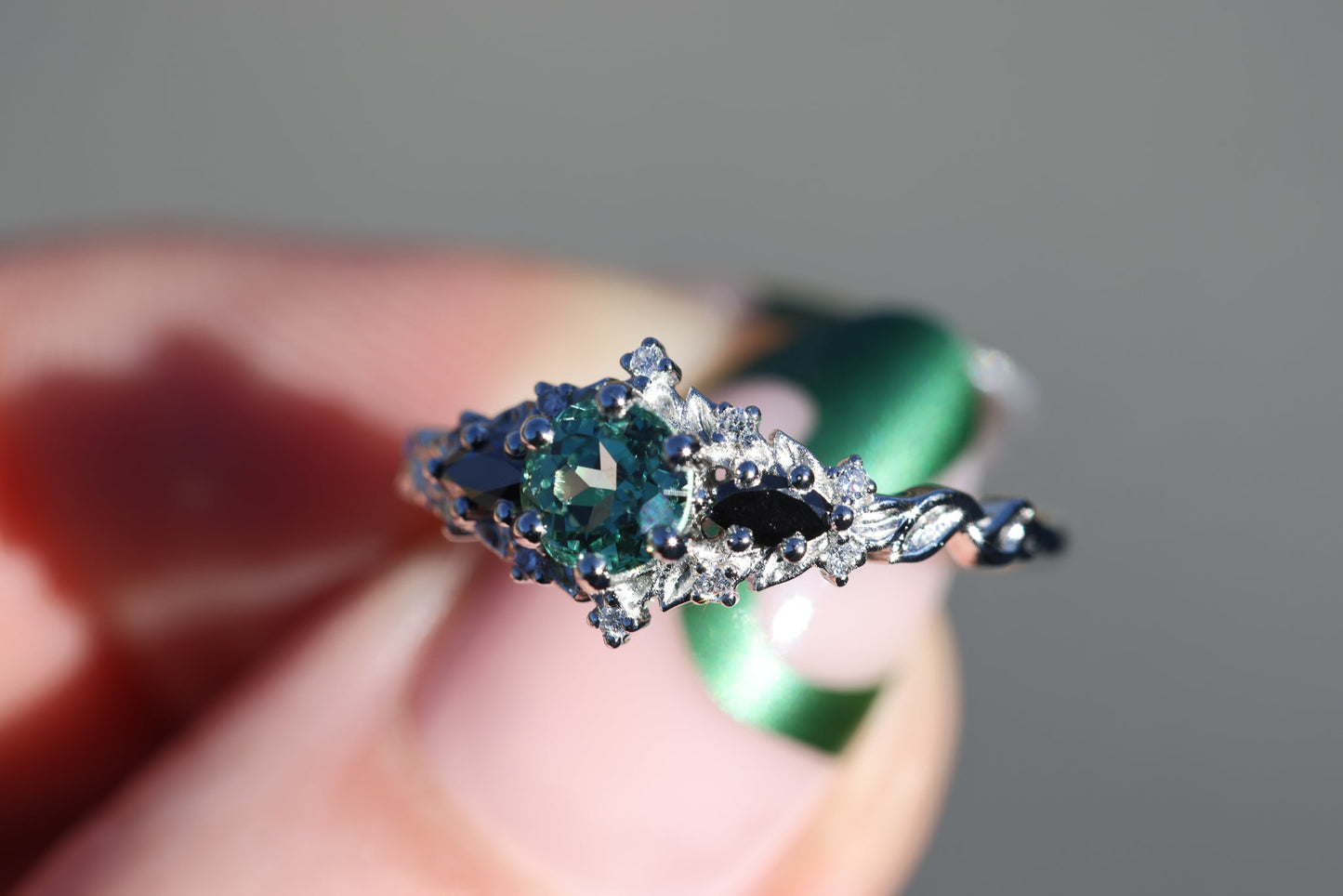 Briar rose three stone with round lab green sapphire center and black diamonds