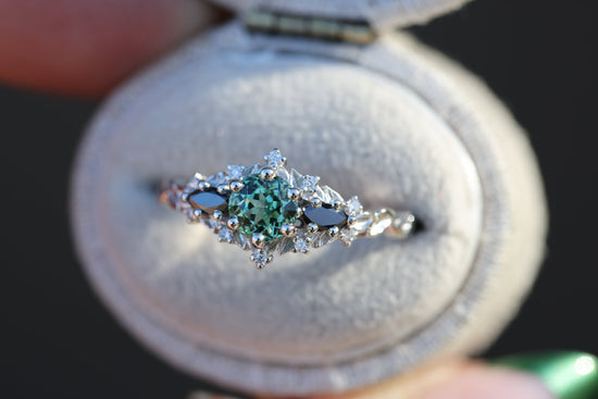 Briar rose three stone with round lab green sapphire center and black diamonds