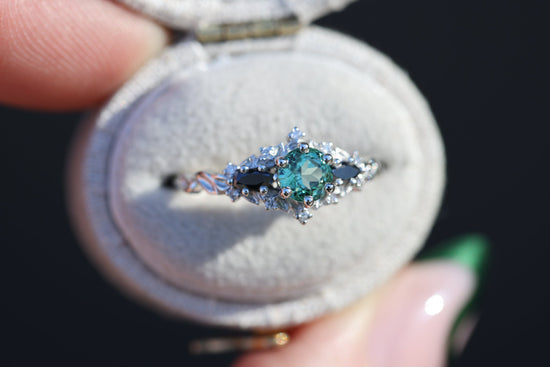 Briar rose three stone with round lab green sapphire center and black diamonds