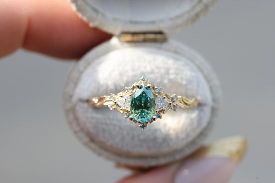 Briar rose three stone with 8x5mm pear teal moissanite center and mint diamonds