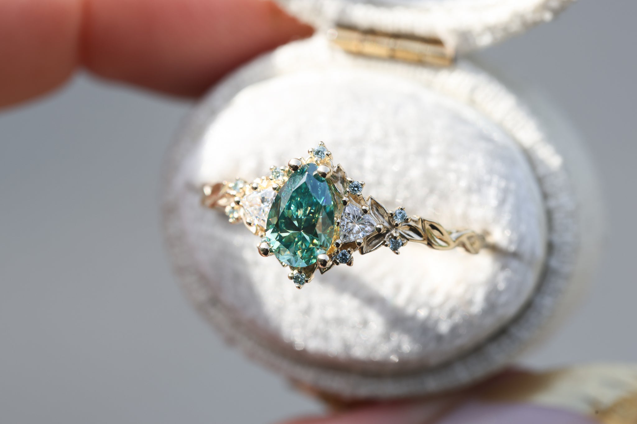 Briar Rose Three Stone with 8x5mm pear teal moissanite center and