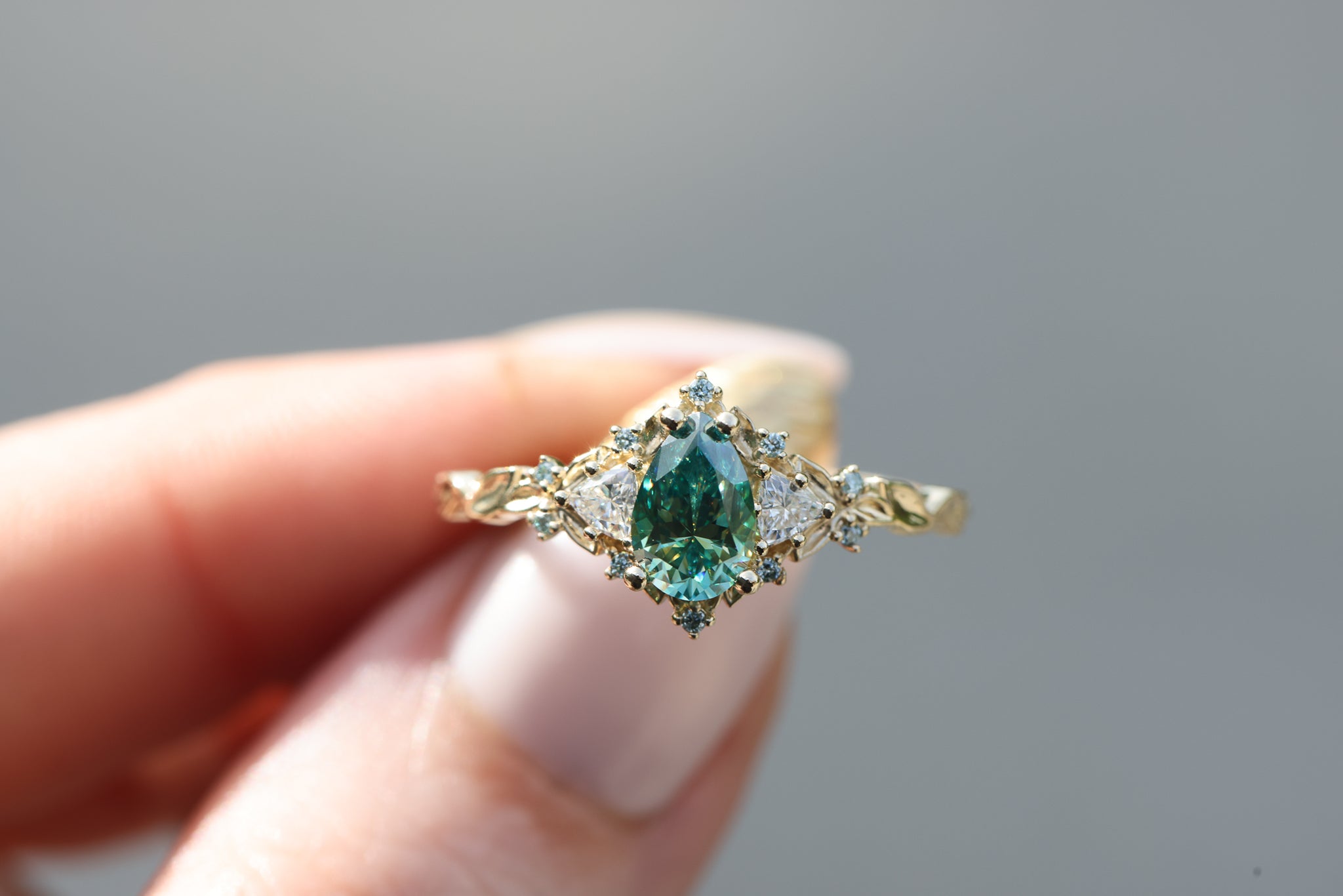 Briar Rose Three Stone with 8x5mm pear teal moissanite center and