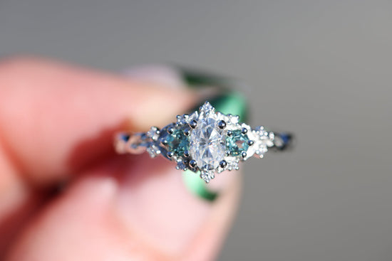 Briar rose three stone with moissanite and round lab green sapphire sides
