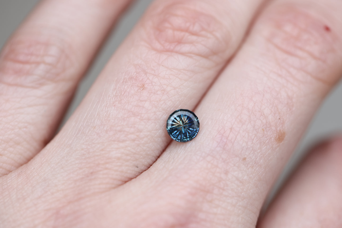 .69ct round parti sapphire, Starbrite cut by John Dyer