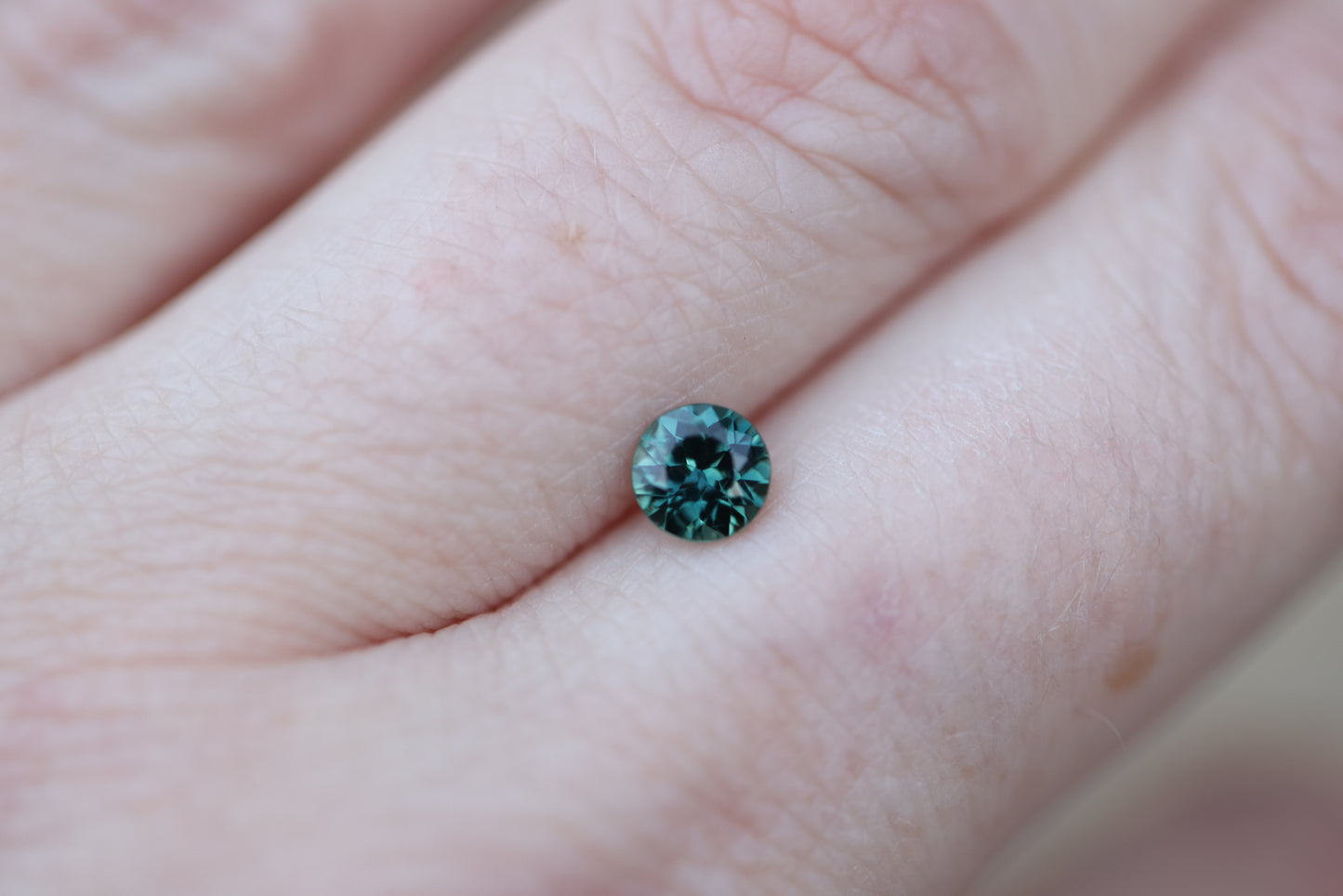 .62ct round teal green sapphire