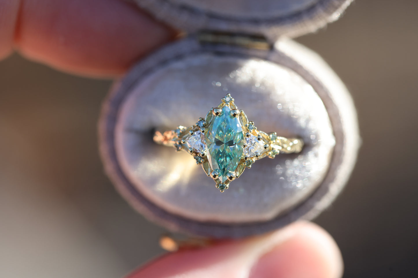 Briar Rose Three Stone with 10x5mm marquise teal moissanite, mint diamond accents