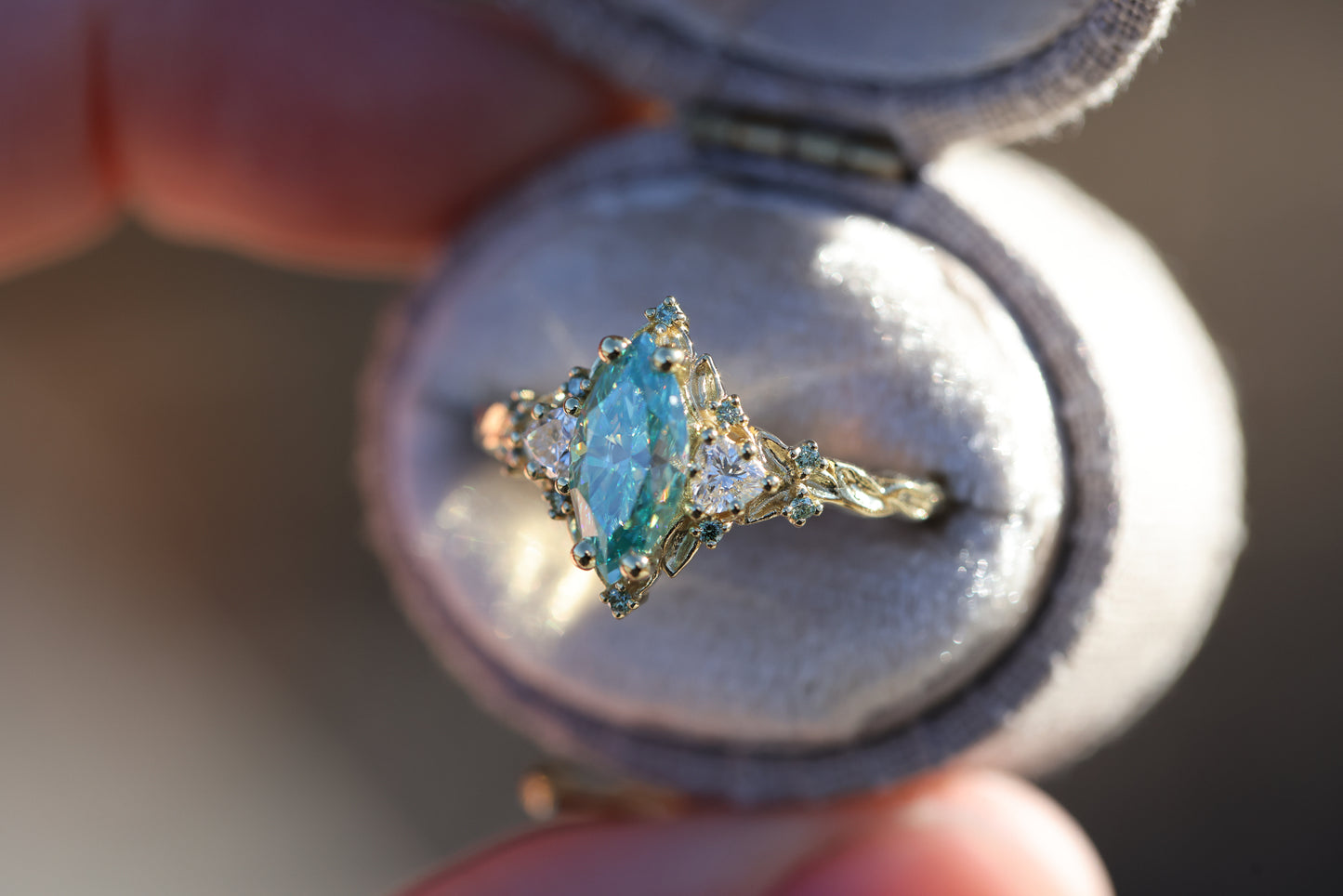 Briar Rose Three Stone with 10x5mm marquise teal moissanite, mint diamond accents