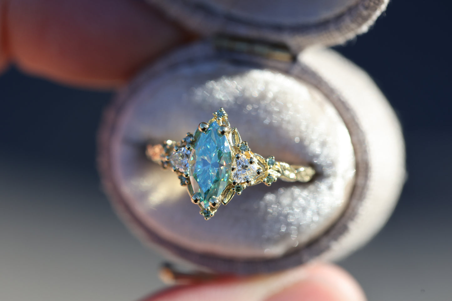 Briar Rose Three Stone with 10x5mm marquise teal moissanite, mint diamond accents