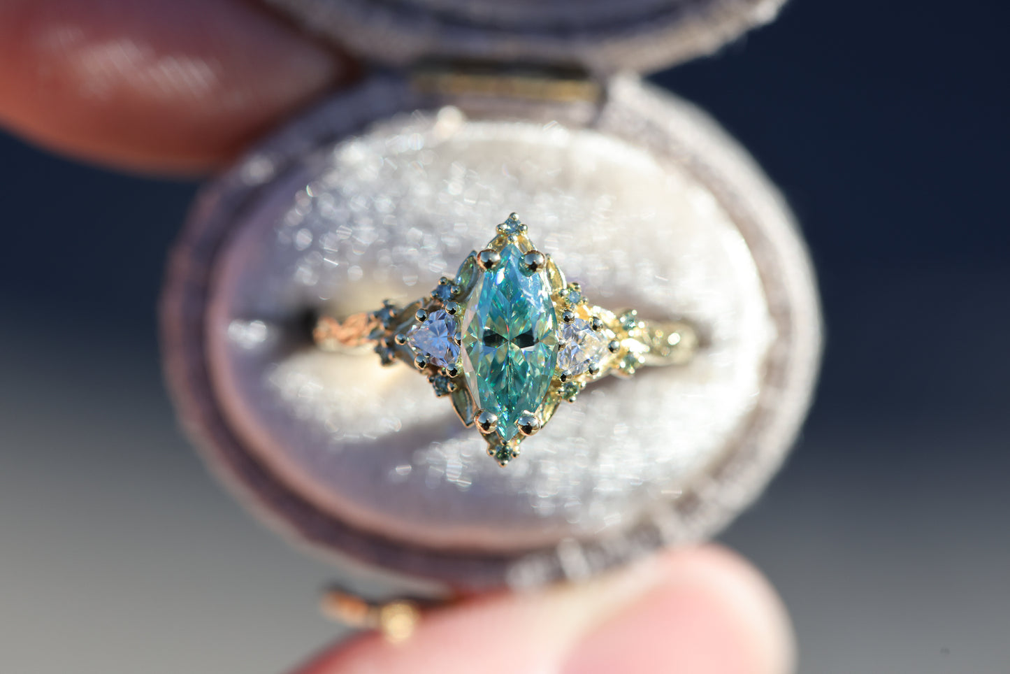 Briar Rose Three Stone with 10x5mm marquise teal moissanite, mint diamond accents