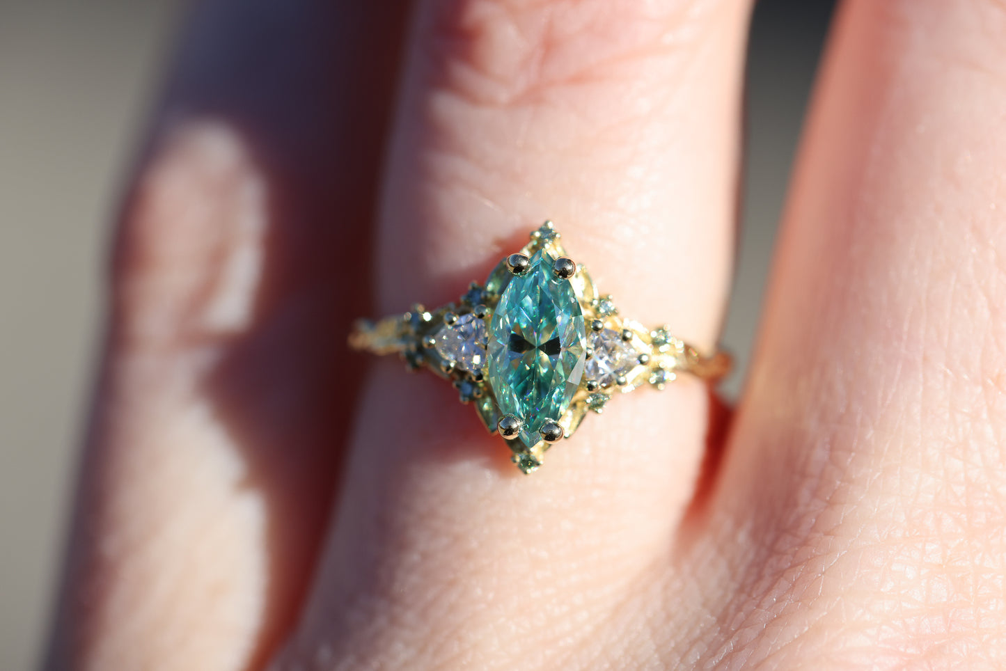 Briar Rose Three Stone with 10x5mm marquise teal moissanite, mint diamond accents