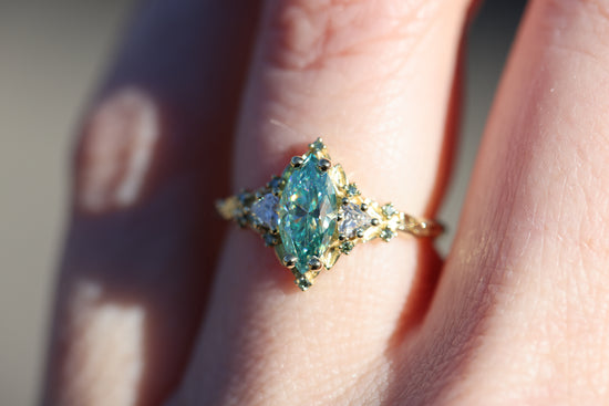 Briar Rose Three Stone with 10x5mm marquise teal moissanite, mint diamond accents