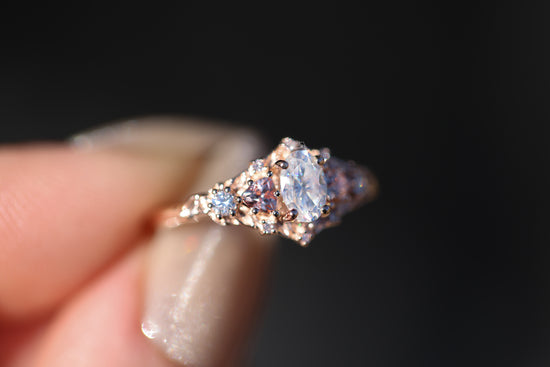 Briar rose five stone with moissanite center and lab peach sapphire sides