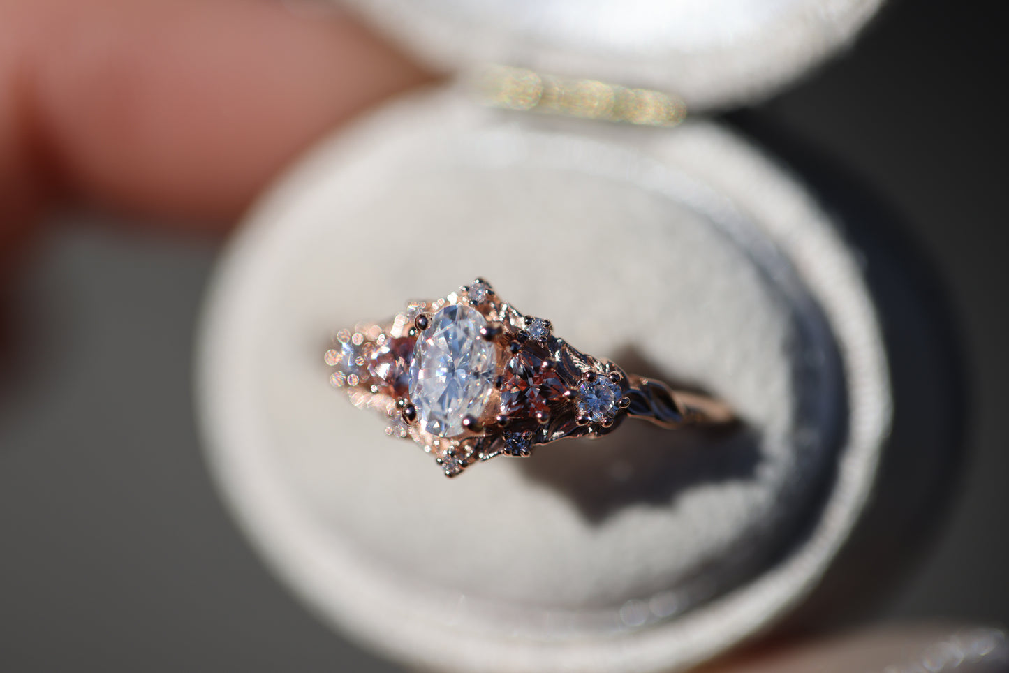Briar rose five stone with moissanite center and lab peach sapphire sides