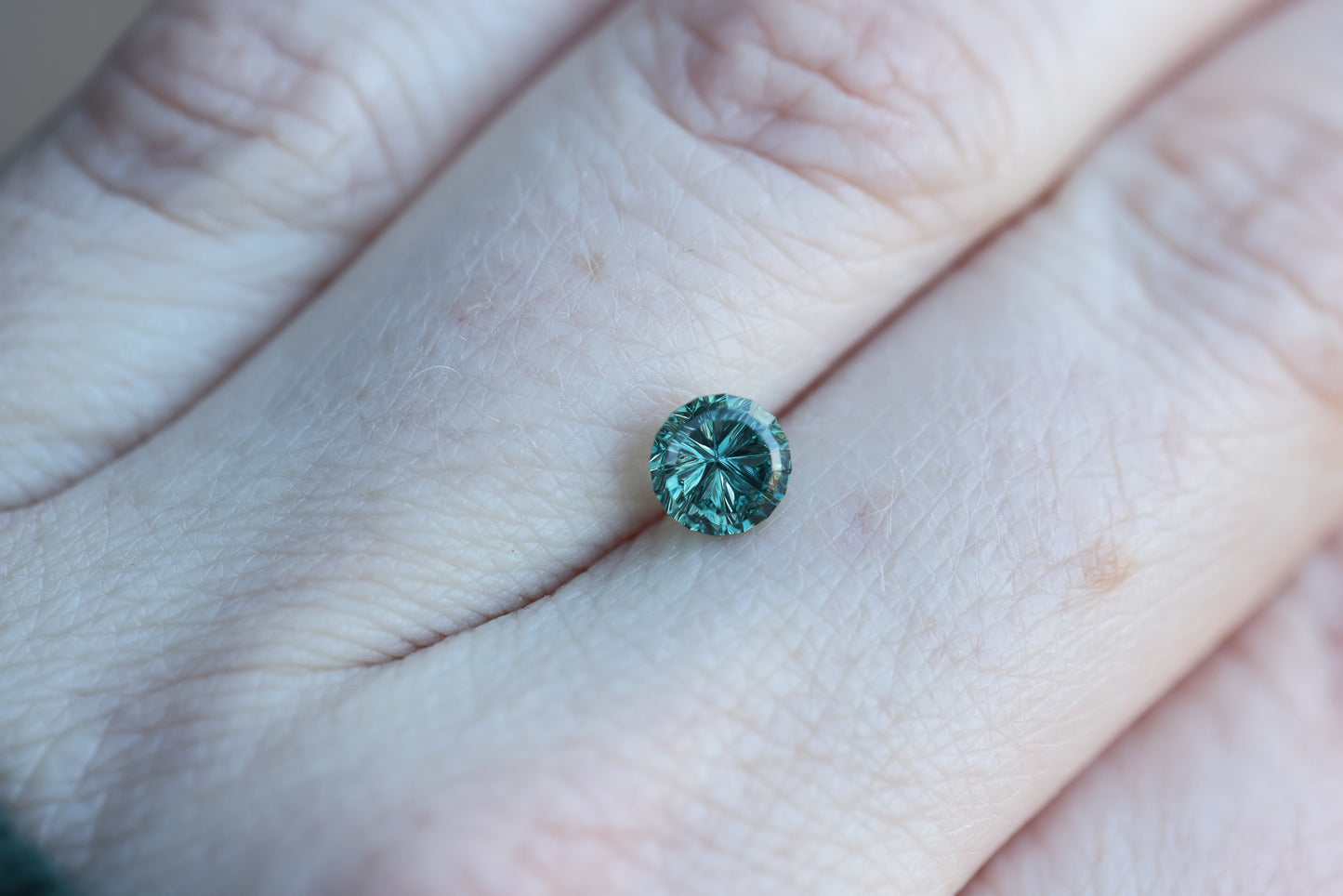 1.22ct round teal sapphire- Starbrite cut by John Dyer
