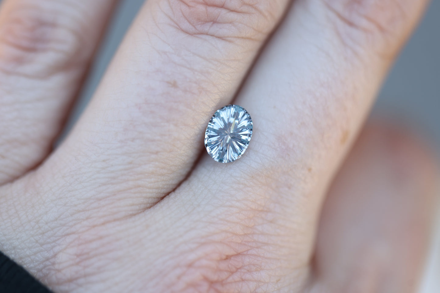 .92ct oval color change from light blue to a very light purple sapphire, Starbrite cut by John Dyer