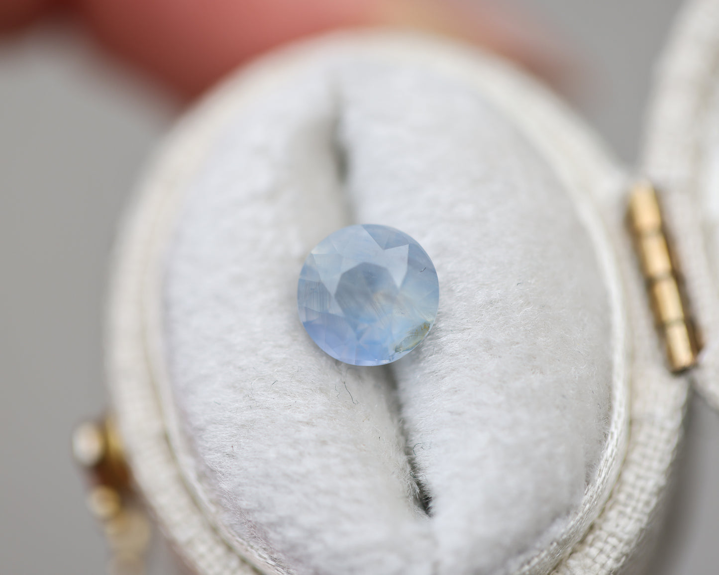1.73ct round opalescent light blue sapphire