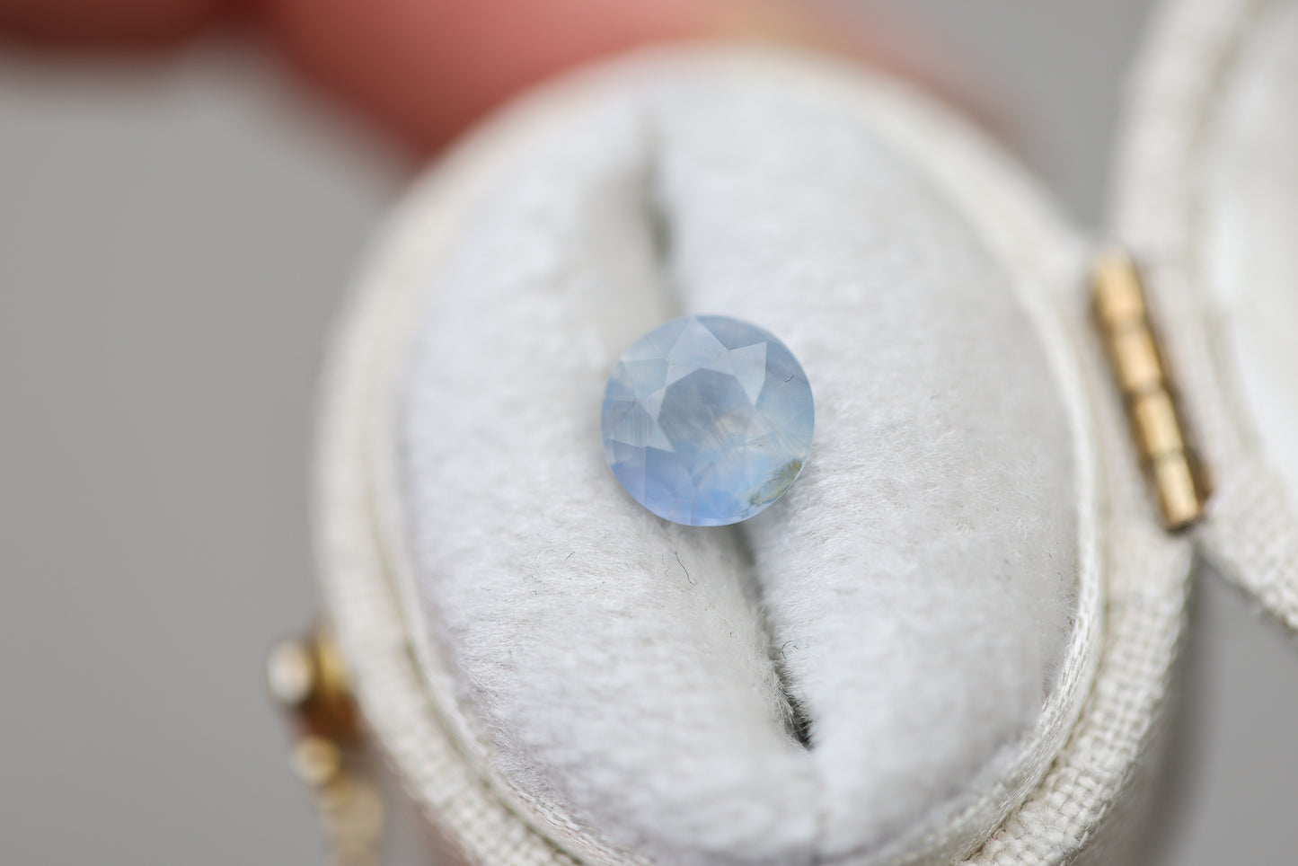 1.73ct round opalescent light blue sapphire