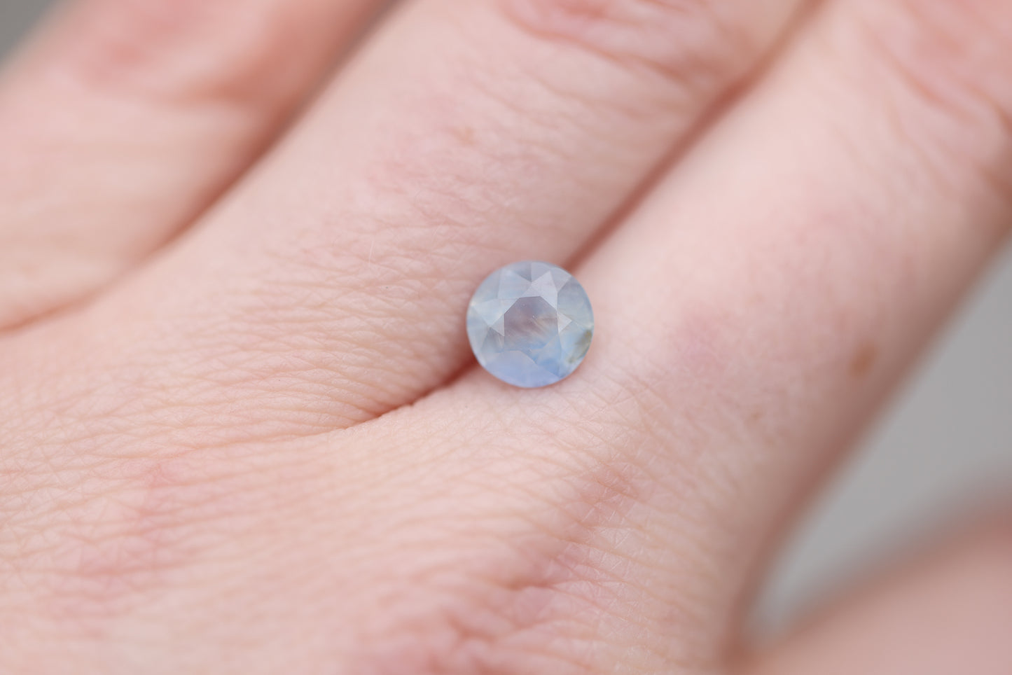 1.73ct round opalescent light blue sapphire