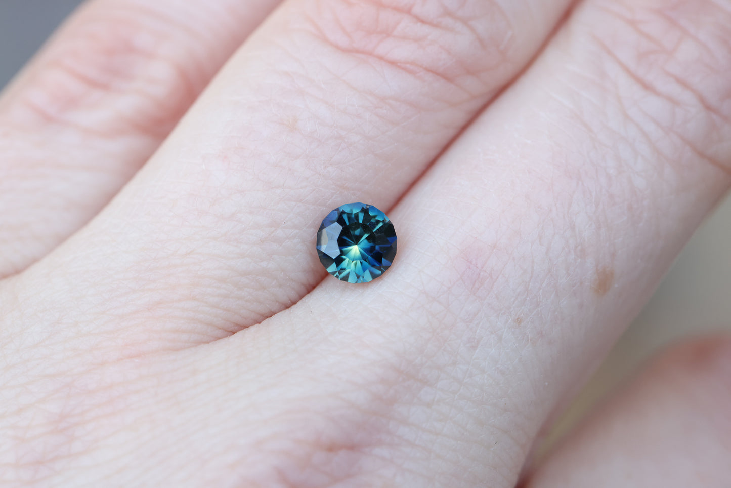 1.21ct round blue teal sapphire, Sunburst cut by John Dyer