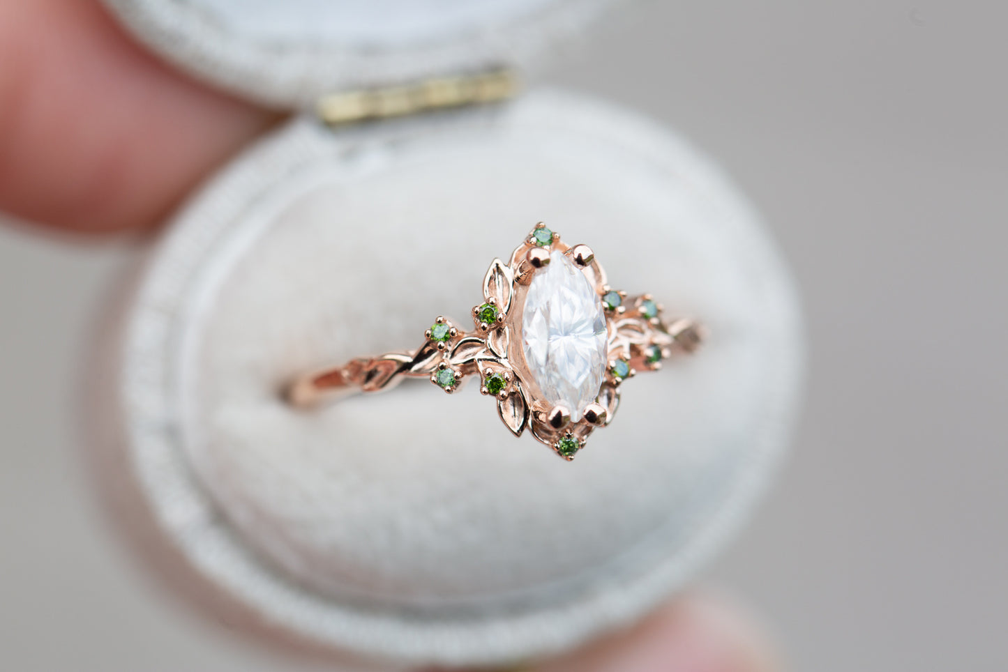 Briar rose halo with marquise moissanite and green diamond accents