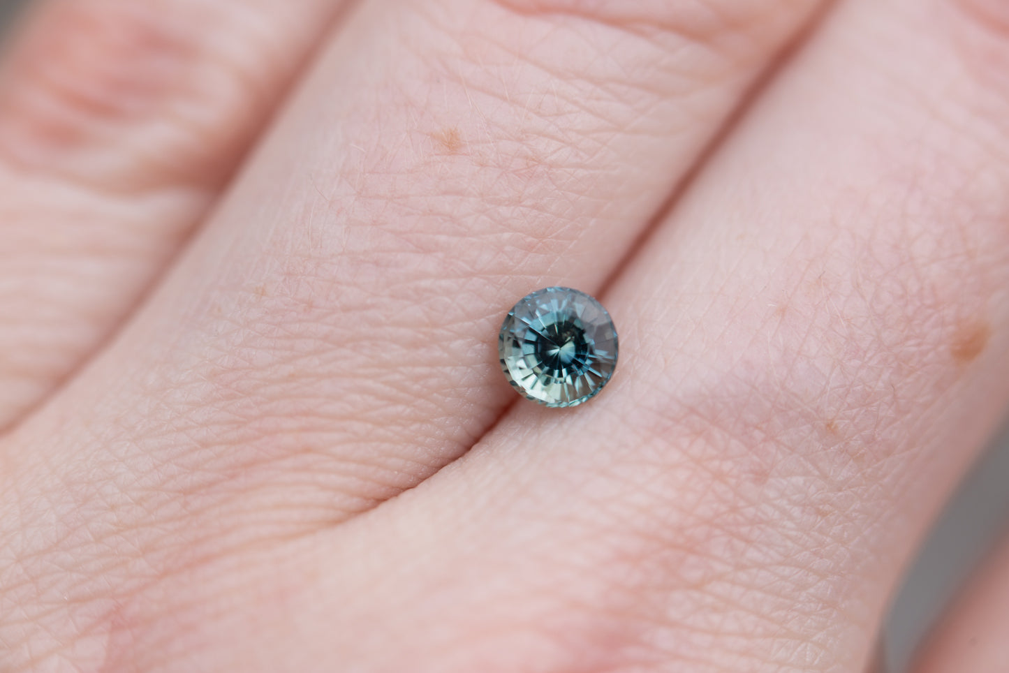 ON HOLD .85ct round blue green sapphire