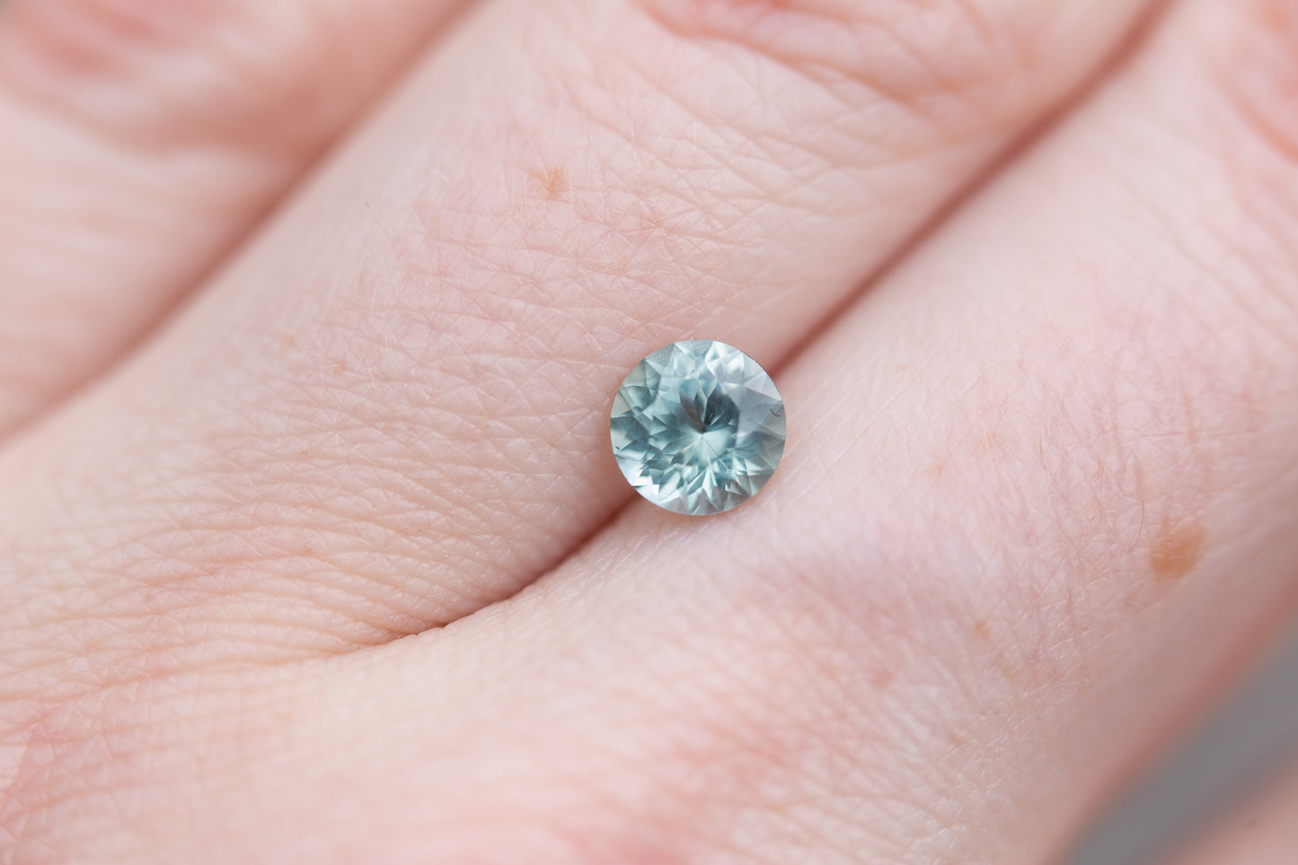 1.02ct round light teal blue sapphire