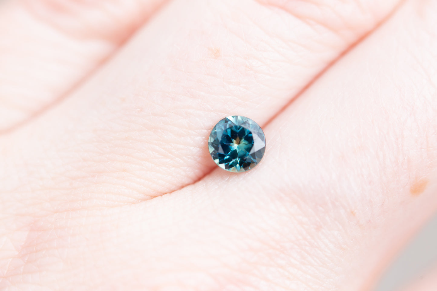 .97ct round deep blue green sapphire