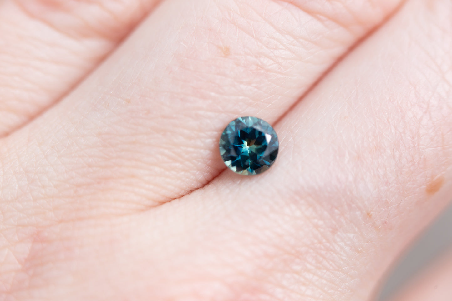 .97ct round deep blue green sapphire