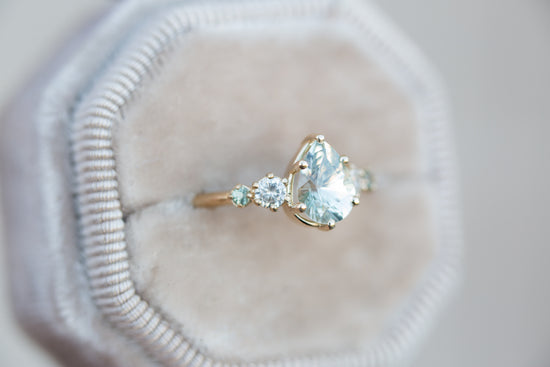 Pastel seafoam pear sapphire five stone ring with diamond side stones