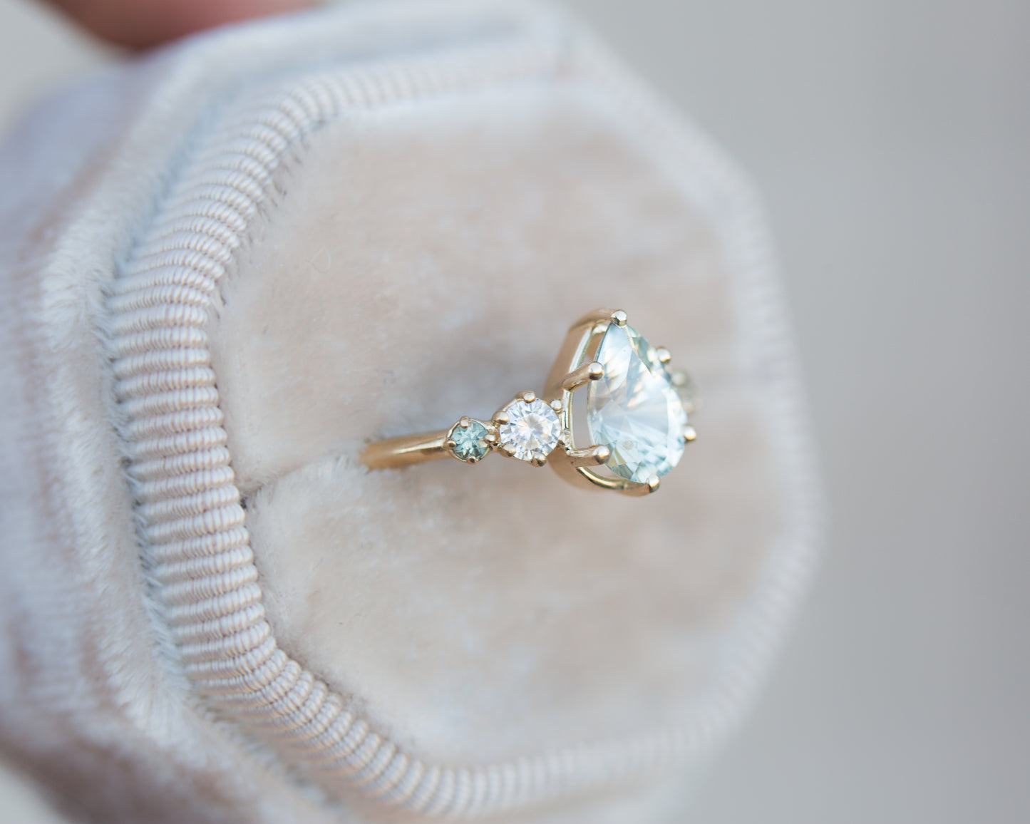 Pastel seafoam pear sapphire five stone ring with diamond side stones