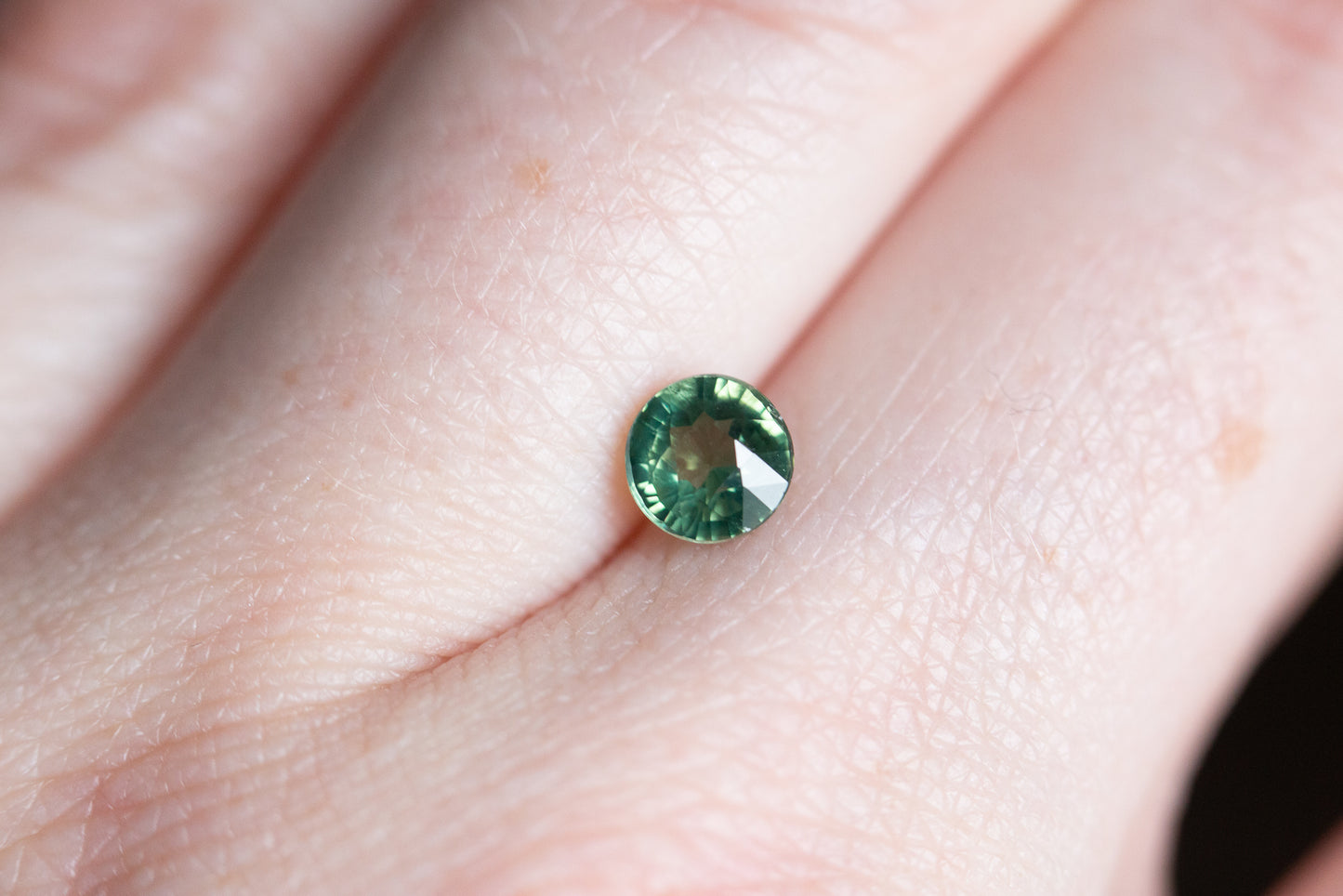 1.1ct round teal green sapphire